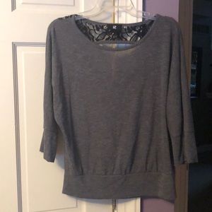 Gray sweater with open back at the top